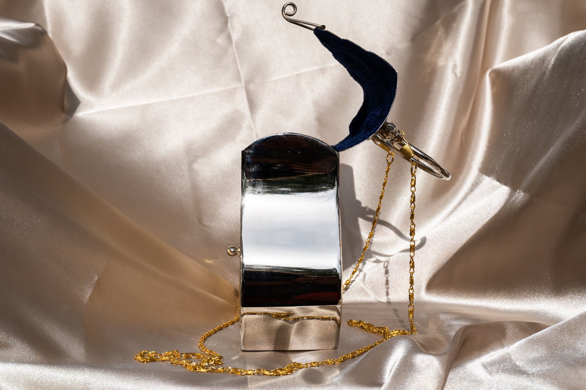 Ida - Handmade Bag, close-up side view with open  blue velvet interior and chain